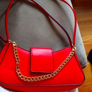 A small, red, seductive shoulder bag for any situation